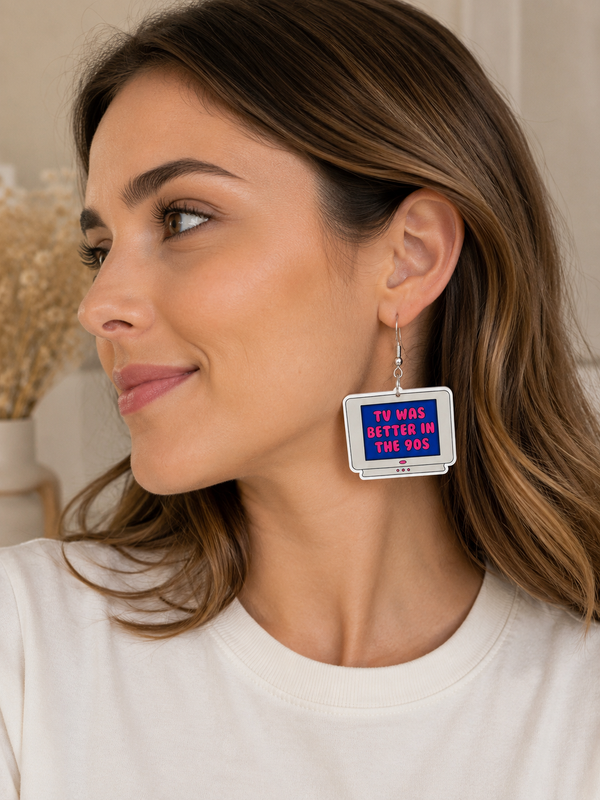 Close-up of a model wearing a single retro television dangle earring with 90s slogan