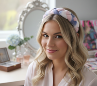 Woman wearing a pink, lilac and white braided fabric headband, front view
