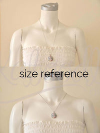 Necklace shown on mannequin bust, two size reference views of pendant on chest