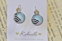 Round silver dangle earrings with blue and black chevron pattern on Kaboodle card
