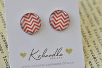 Round stud earrings with red and white chevron pattern displayed on Kaboodle card
