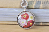 Round glass pendant necklace with vintage red, pink and yellow floral print, front view