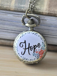 Bronze pocket watch necklace pendant with a floral wreath and Hope artwork on the lid
