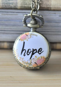 Bronze pocket watch necklace with floral wreath and hand-lettered hope design on white face