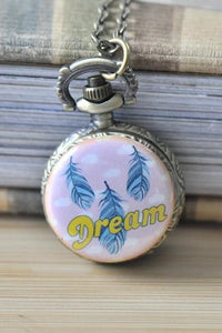 Bohemian feather dream pocket watch necklace with painted feathers and Dream script on pink dial
