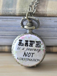 Antique bronze pocket watch necklace with 'Life Is A Journey Not A Destination' quote on floral background