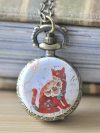 Pocket watch necklace with red cat and floral artwork on an antique bronze case