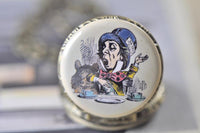Close-up of the Mad Hatter tea party illustration on the pocket watch pendant lid
