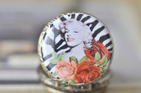 Close-up of Marilyn Monroe zebra print and rose design pocket watch pendant