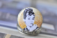 Close-up of the pocket watch pendant lid showing the vintage-style portrait artwork