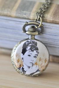 Antique bronze pocket watch necklace featuring a portrait of Audrey Hepburn on a diamond-patterned background