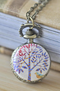 Bronze pocket watch necklace with tree and bird artwork on the front cover