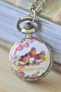 Bronze pocket watch necklace with a trio of bluebirds and pink roses design