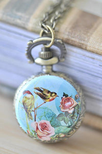 Bronze pocket watch necklace with vintage bird and rose artwork on the pendant lid