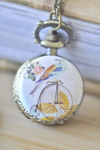 Penny farthing and bird pocket watch necklace pendant with rose detail on antique brass case
