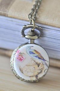 Bronze pocket watch necklace with vintage bird, teapot and rose artwork on the cover