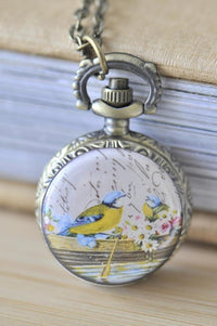Bronze pocket watch necklace with love birds in a rowboat design on the front cover