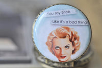Close up of retro pin up girl pendant with sassy quote on pocket watch necklace