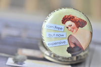 Close-up of the pin up girl pocket watch pendant resting on a book