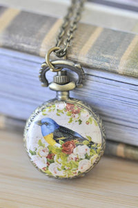 Bronze pocket watch necklace with bluebird and rose artwork on the front cover