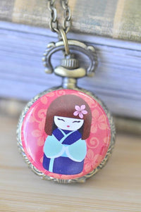 Kokeshi doll pocket watch necklace with pink floral background and antique bronze case