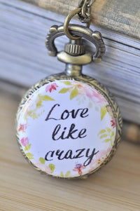 Antique bronze pocket watch necklace with hand-lettered "Love Like Crazy" quote and floral watercolour design