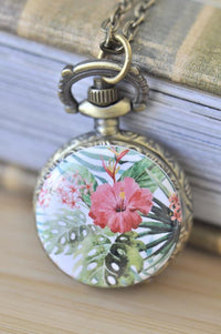 Bronze pocket watch necklace with tropical hibiscus and palm leaf print pendant