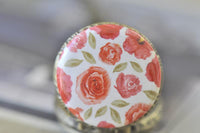 Close-up of the watercolour rose pattern on the pocket watch pendant lid