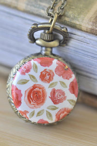 Antique bronze pocket watch necklace with a watercolour rose and leaf design on the front cover