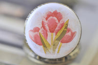 Close-up of the watercolour tulip artwork on the pocket watch pendant cover