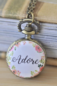 Antique bronze pocket watch necklace with floral wreath and 'Adore' script design