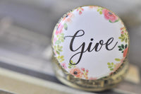 Close-up of "Give" floral pocket watch pendant lid with pink and green watercolour flowers