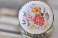 Close-up of the watercolour flower design on the pocket watch pendant lid