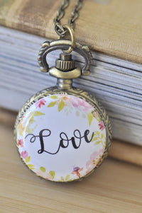 Bronze pocket watch necklace with floral wreath and Love lettering on the front cover