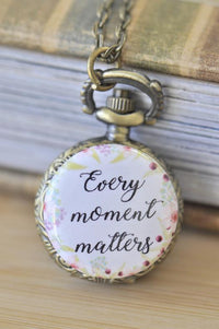 Bronze pocket watch necklace with floral "Every moment matters" quote on the front cover