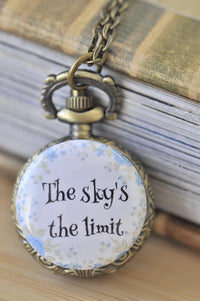 Pocket watch necklace pendant with blue floral border and "The sky's the limit" quote
