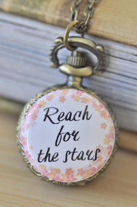 Reach for the Stars pocket watch necklace with pink and gold floral design on bronze pendant