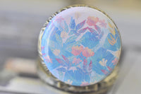 Detailed view of the watercolour flower design on the pocket watch pendant lid