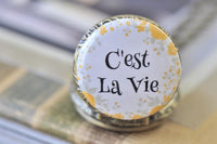 Close up of the C'est La Vie pocket watch pendant lid with yellow floral border detail