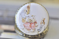 Close-up of the Peter Rabbit bunny family artwork inside the pocket watch pendant