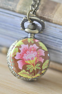Bronze pocket watch necklace with pink and green vintage floral artwork on the case front