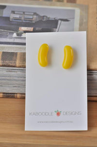 Yellow jelly bean shaped resin stud earrings on Kaboodle Designs card