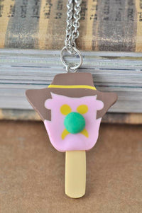 Close-up of ice cream face pendant necklace with brown hat, pink body and green nose detail