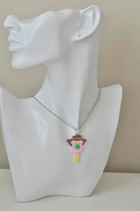 Ice cream face pendant necklace worn on a display bust with silver-tone chain