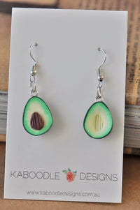 Polymer clay avocado half drop earrings on Kaboodle Designs card, front view showing pit and pit-hollow sides