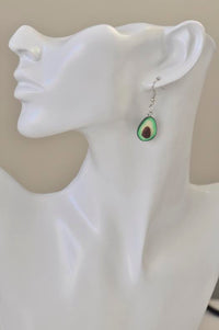 Avocado earring worn on model's ear, close-up profile view
