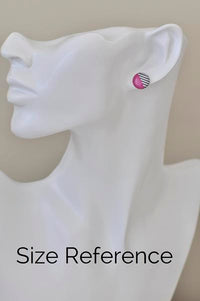 Single red and striped stud earring worn on ear for size reference
