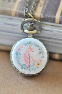 Boho unicorn pocket watch necklace with floral wreath artwork and bronze-tone chain