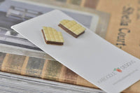 Two white chocolate bar resin stud earrings on a Kaboodle Designs card, angled view