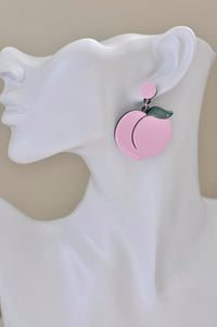 Pink peach earring shown on model's ear, side profile view